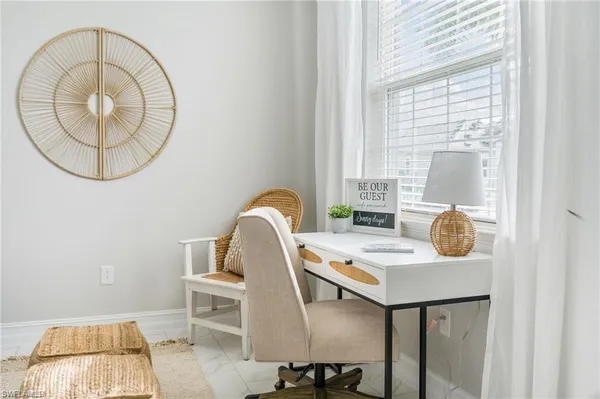 a view of a dining room with furniture and window