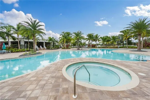 a swimming pool with outdoor seating and garden