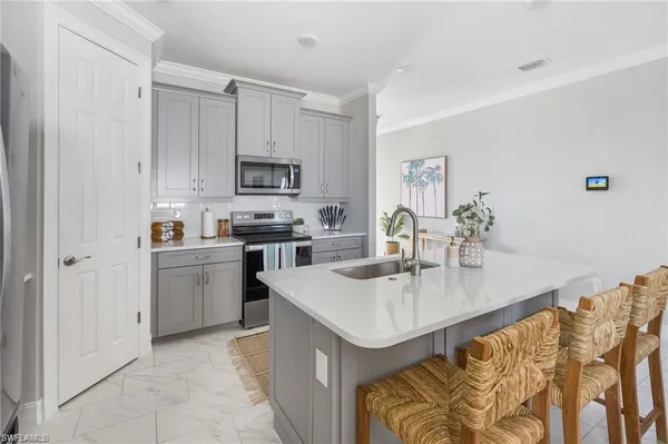 a kitchen with stainless steel appliances granite countertop a sink a stove and a refrigerator