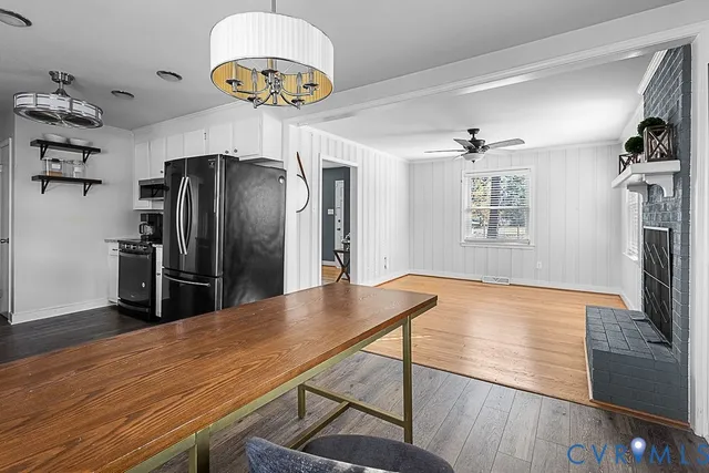 a kitchen with stainless steel appliances granite countertop a refrigerator a stove and a wooden floors