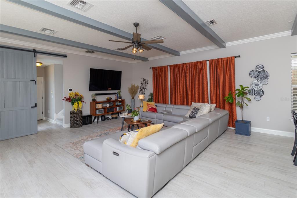 3305 Schoolhouse Road St. Cloud, FL 34773 - Photo 11 of 83 a living room with furniture and a flat screen tv
