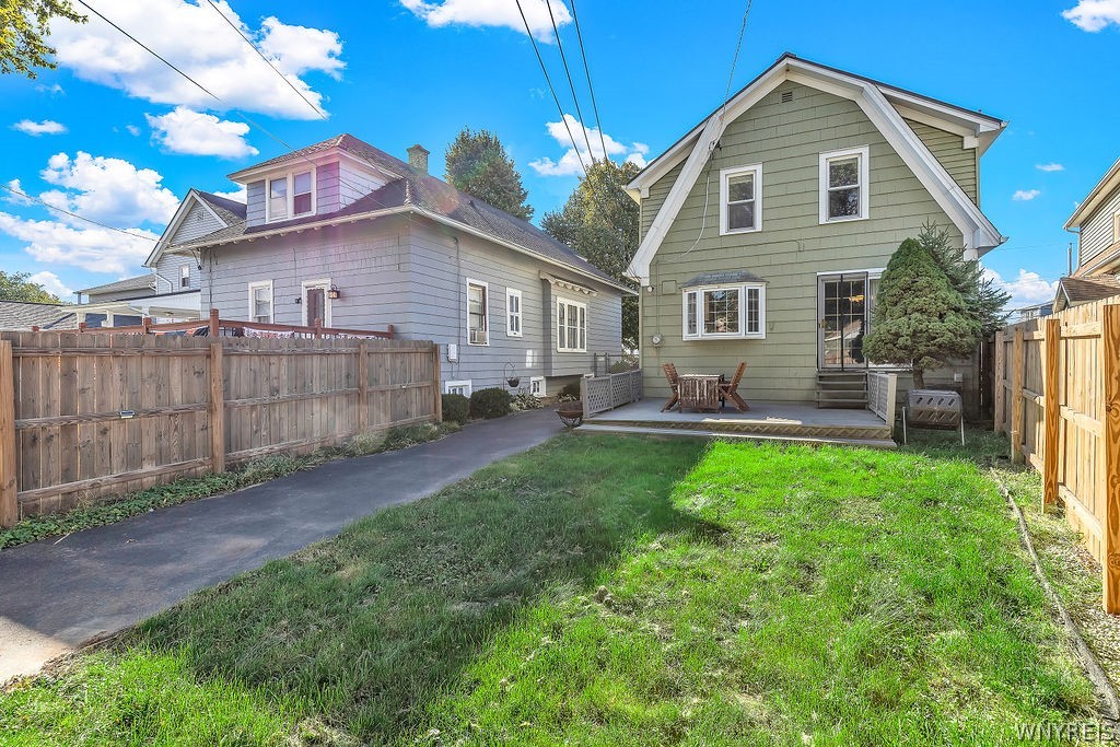 164 Shenandoah Road Buffalo, NY 14220 - Photo 8 of 50 Wooden fencing encloses a grassy backyard with a p