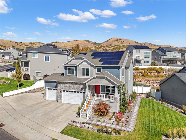 882 Spring Dew Lane Lehi, UT 84048 - Photo 1 of 46 View of front facade with solar panels, a residential view, concrete driveway, and a mountain view