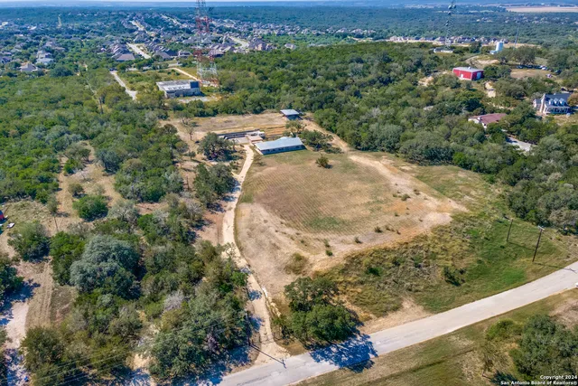 an aerial view of a houses with a yard