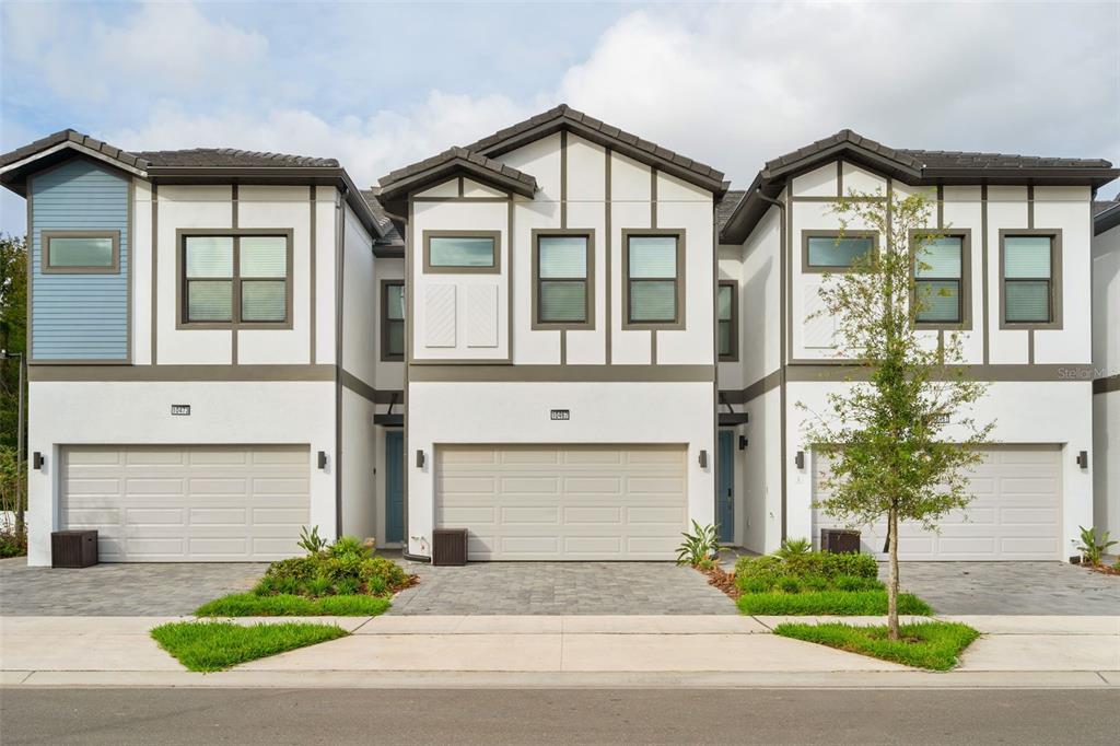 10467 Ebb Tide Lane Orlando, FL 32821 - Photo 1 of 40 a front view of a house with a yard and garage