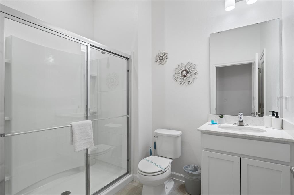 10467 Ebb Tide Lane Orlando, FL 32821 - Photo 12 of 40 a bathroom with a sink a toilet and shower