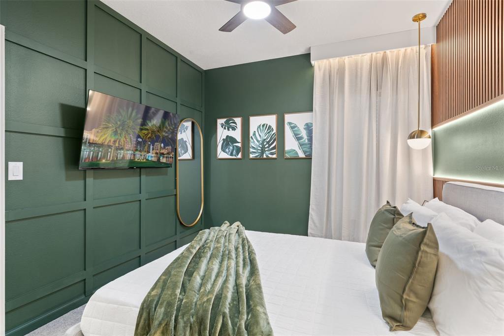 10467 Ebb Tide Lane Orlando, FL 32821 - Photo 27 of 40 a bedroom with a bed and a chandelier