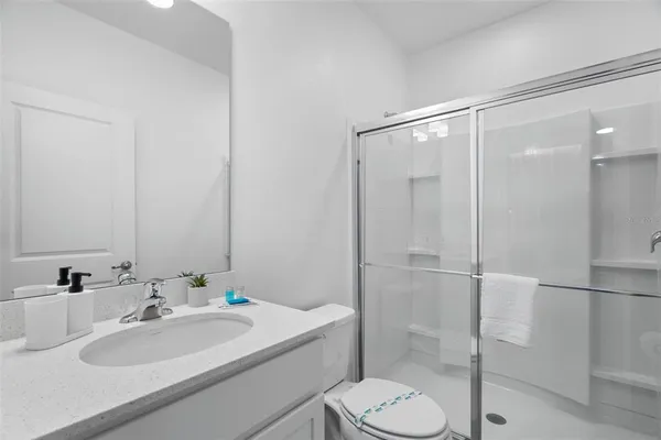 a bathroom with a sink double vanity and toilet