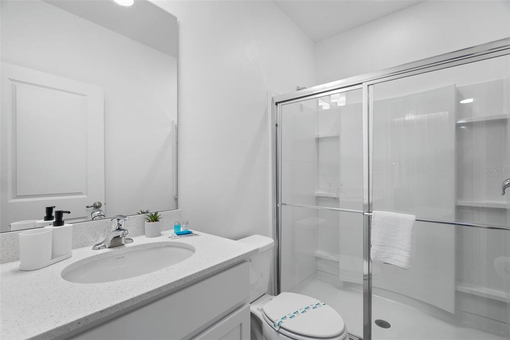 10467 Ebb Tide Lane Orlando, FL 32821 - Photo 28 of 40 a bathroom with a sink toilet and shower