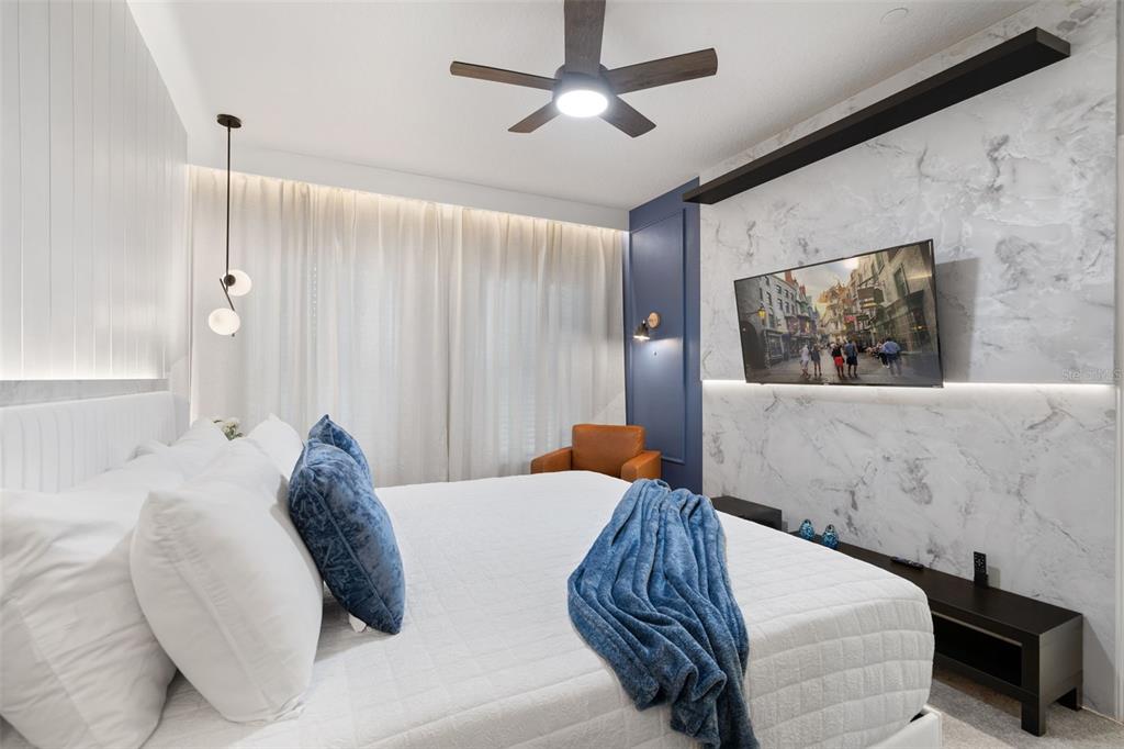 10467 Ebb Tide Lane Orlando, FL 32821 - Photo 30 of 40 a bedroom with a large bed and a flat screen tv