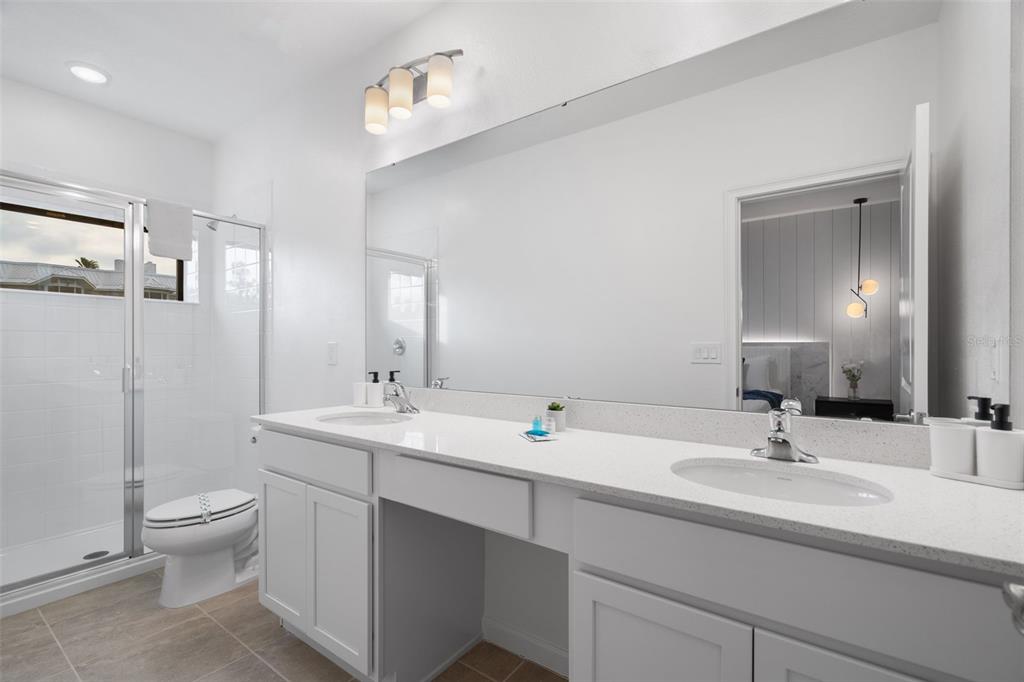 10467 Ebb Tide Lane Orlando, FL 32821 - Photo 31 of 40 a bathroom with a sink double vanity and toilet