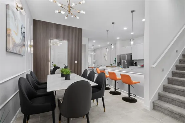 a dining room with furniture and a chandelier