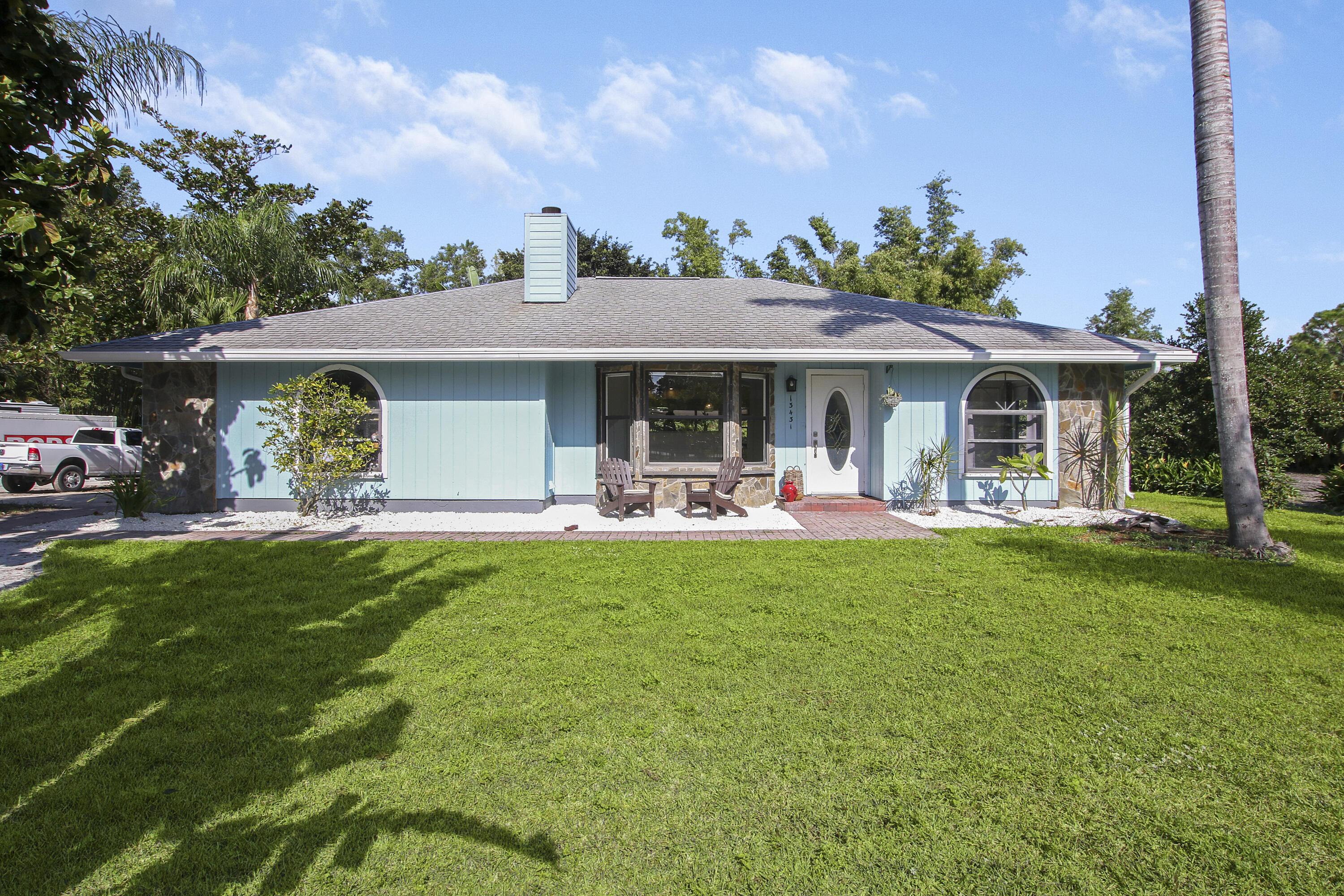 13431 153rd Road North Jupiter, FL 33478 - Photo 1 of 44 a front view of a house with garden