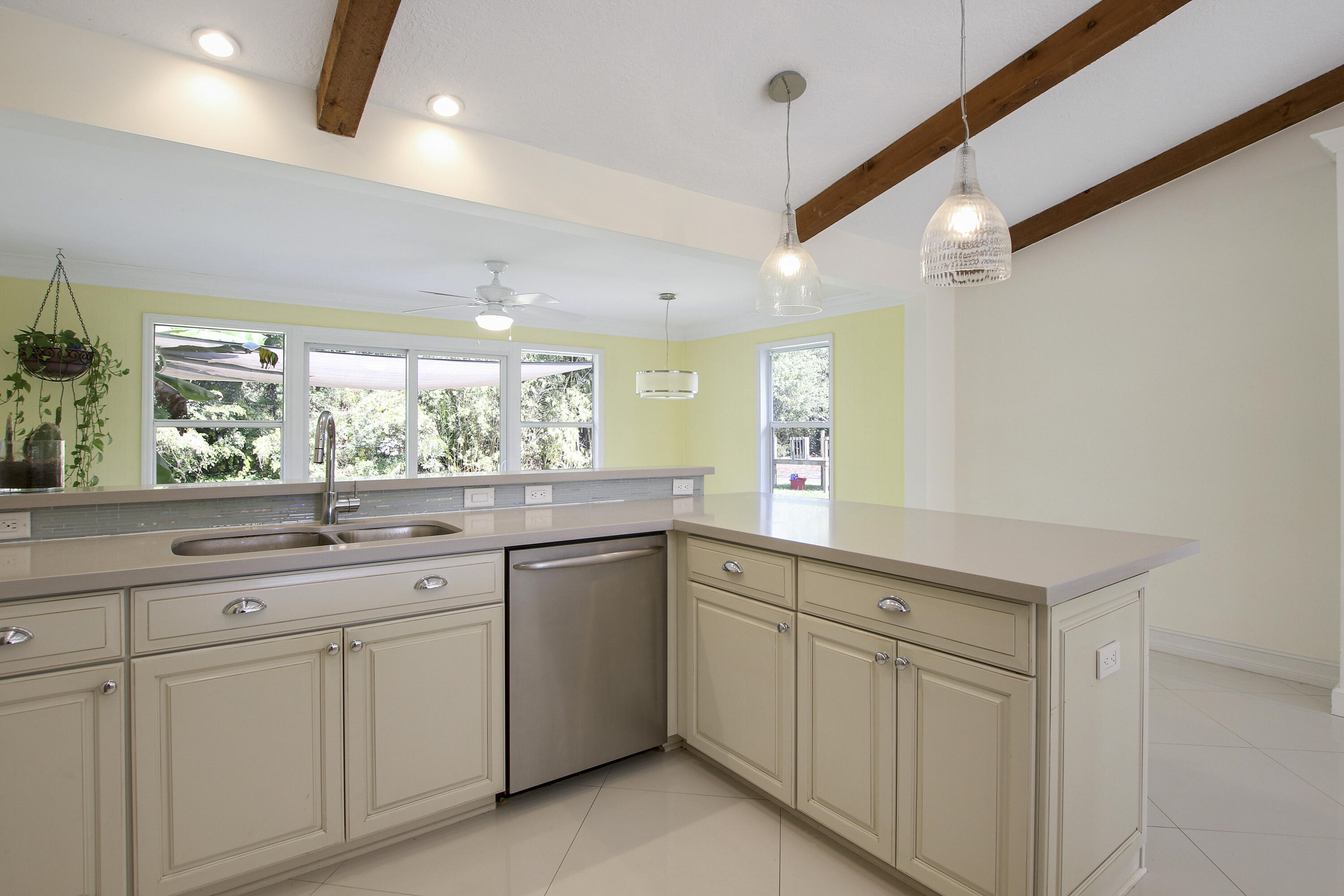 13431 153rd Road North Jupiter, FL 33478 - Photo 11 of 44 a kitchen with white cabinets and sink