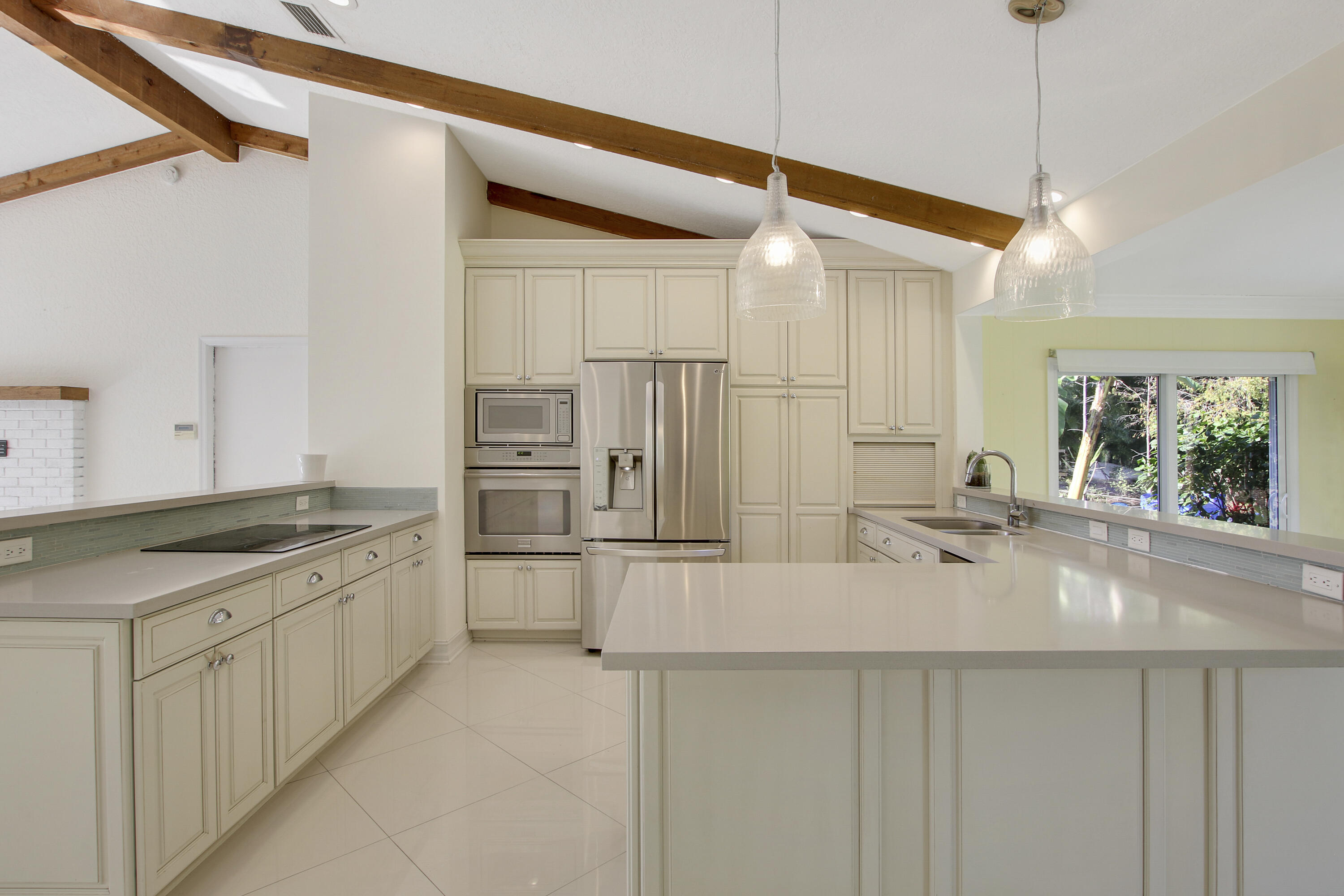 13431 153rd Road North Jupiter, FL 33478 - Photo 12 of 44 a kitchen with stainless steel appliances granite countertop a sink and refrigerator