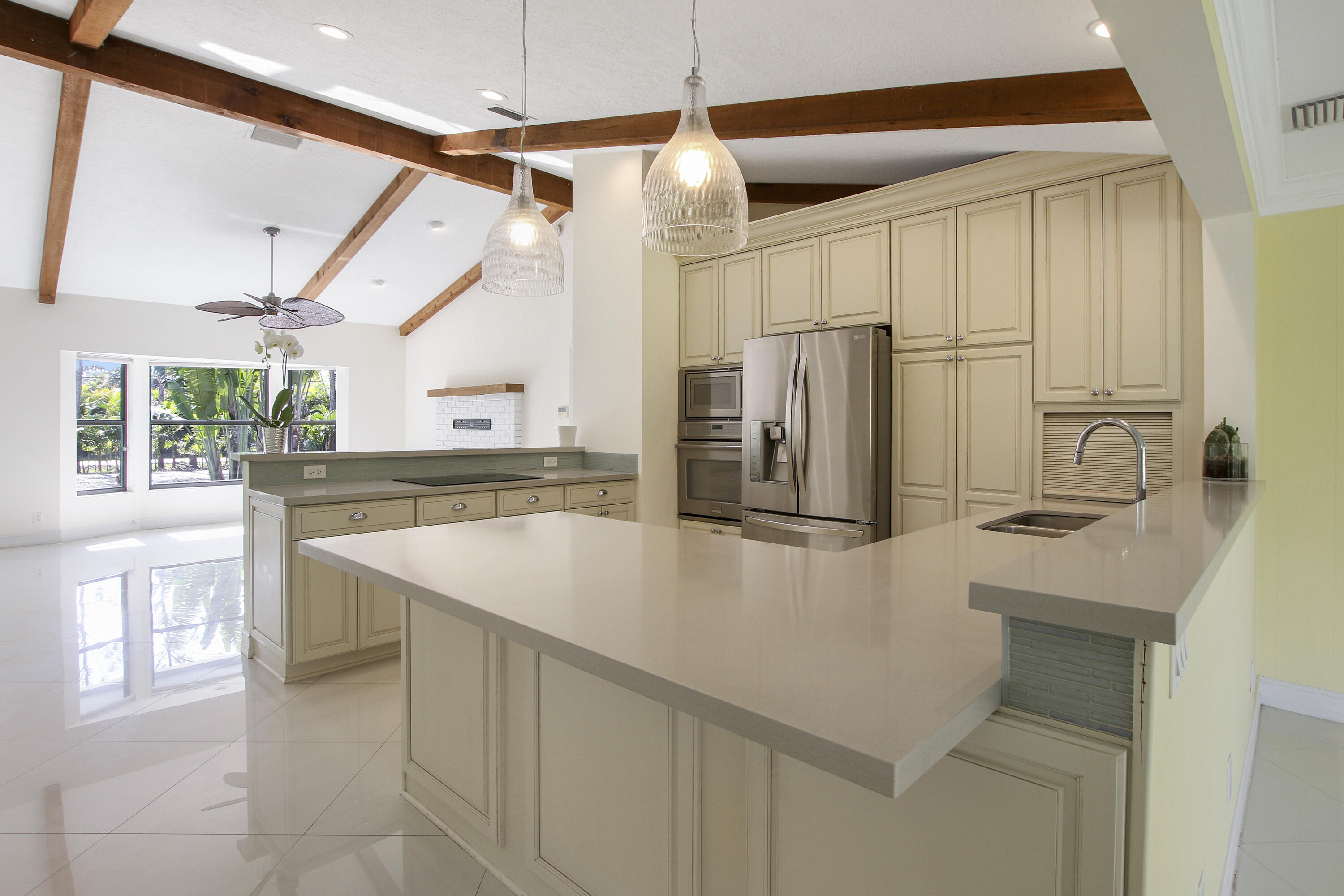 13431 153rd Road North Jupiter, FL 33478 - Photo 13 of 44 a kitchen with stainless steel appliances granite countertop a sink a stove and a refrigerator