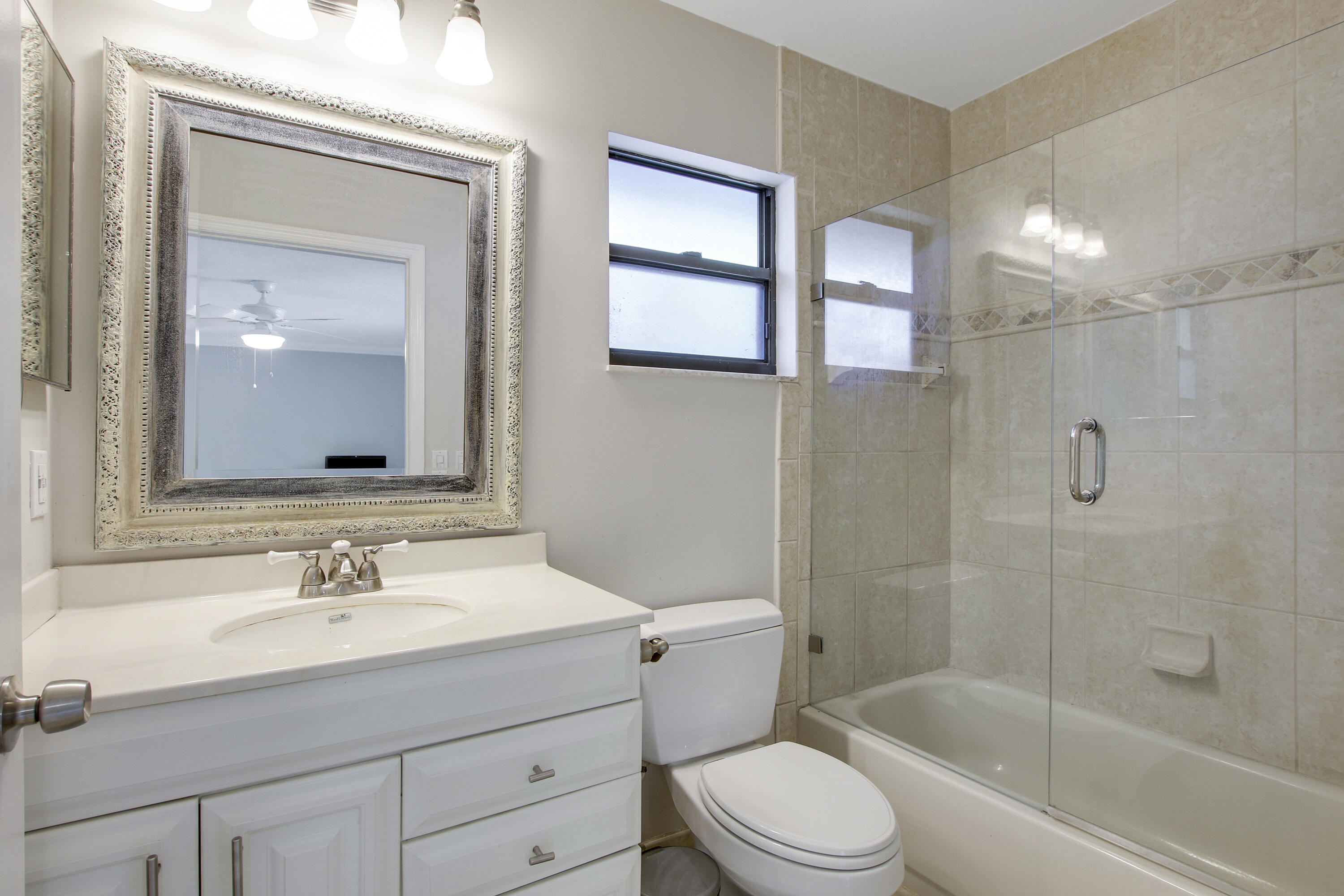 13431 153rd Road North Jupiter, FL 33478 - Photo 16 of 44 a bathroom with a sink a toilet and shower