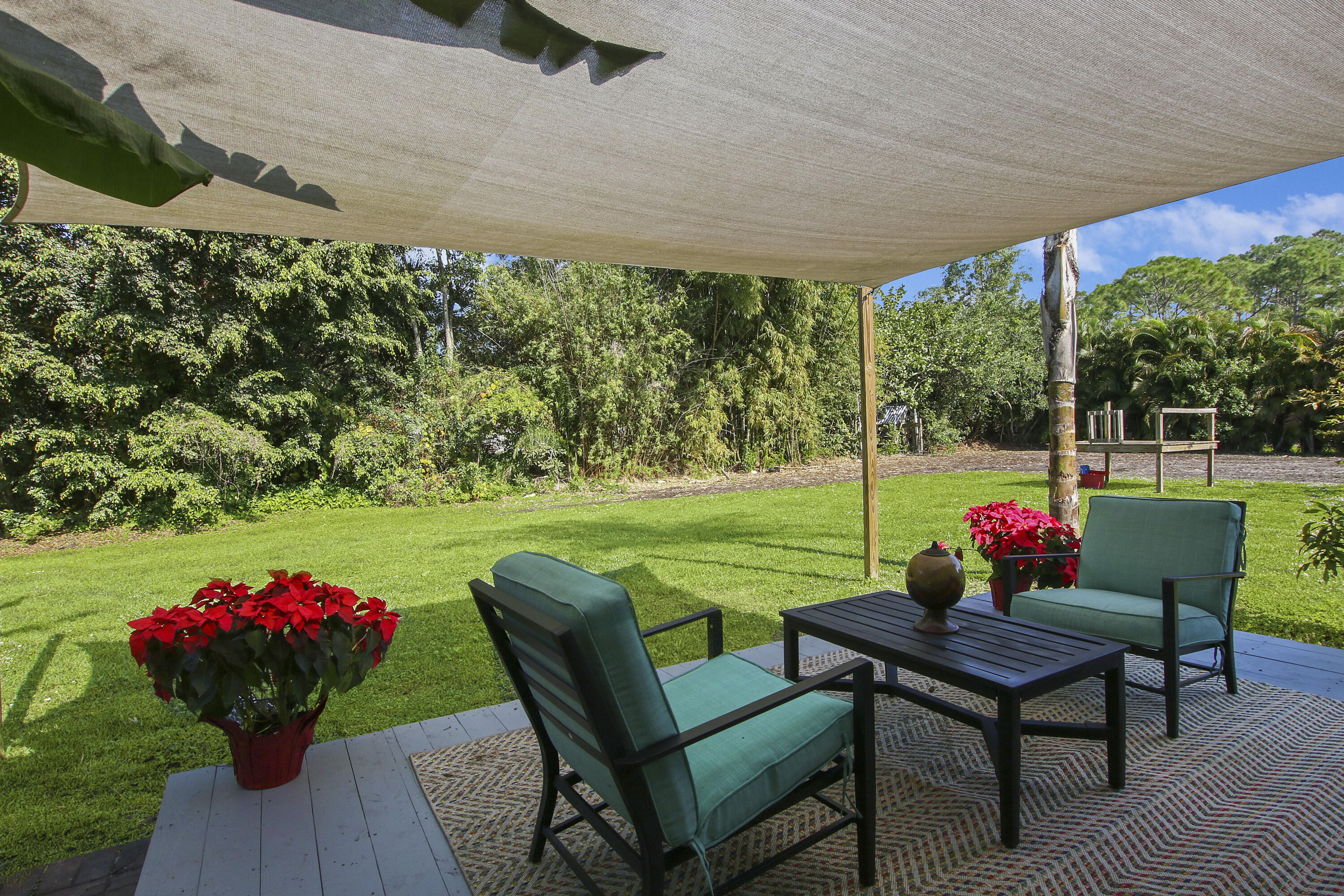 13431 153rd Road North Jupiter, FL 33478 - Photo 23 of 44 a view of a chairs and table in the garden