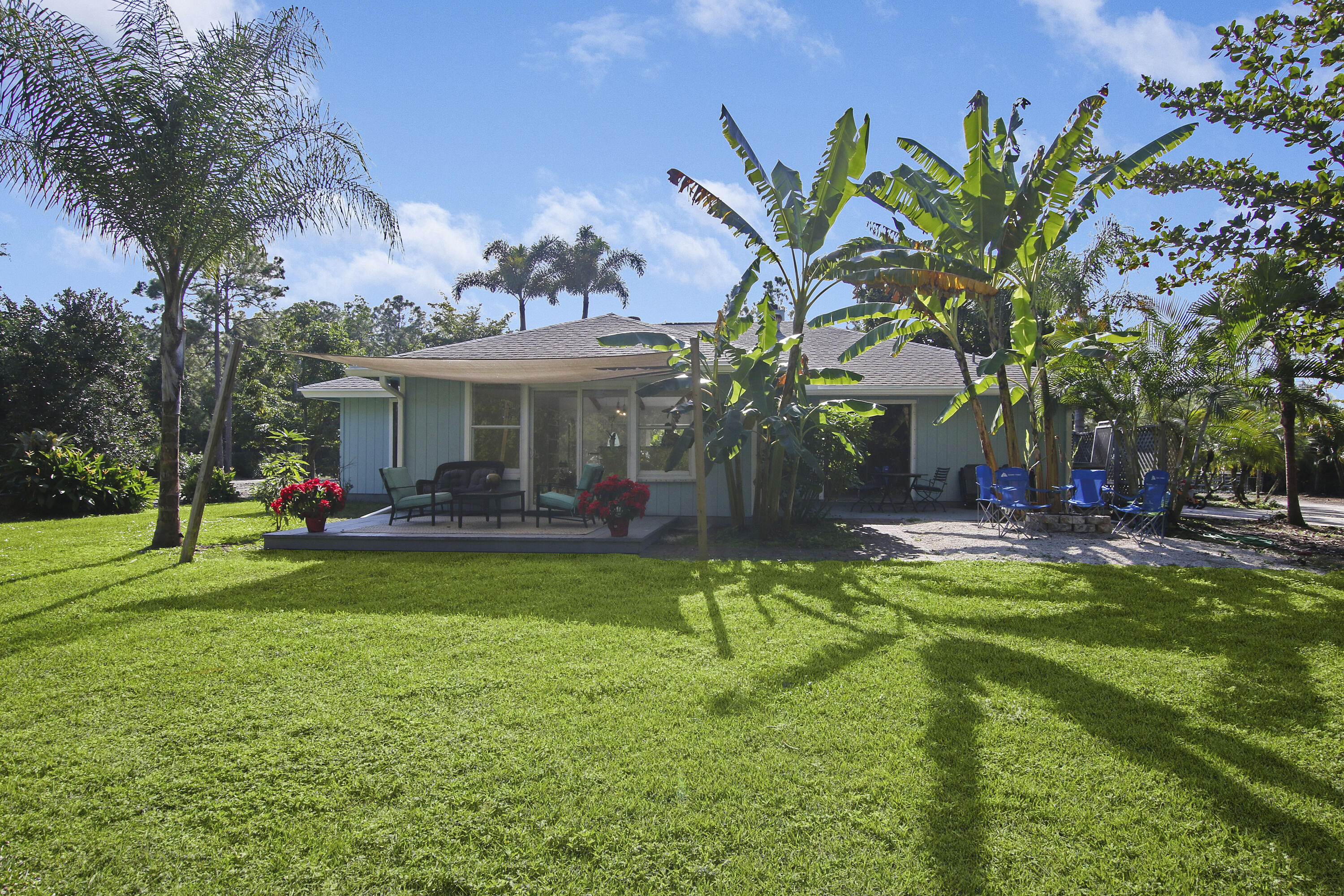 13431 153rd Road North Jupiter, FL 33478 - Photo 34 of 44 a view of a house with swimming pool and sitting area