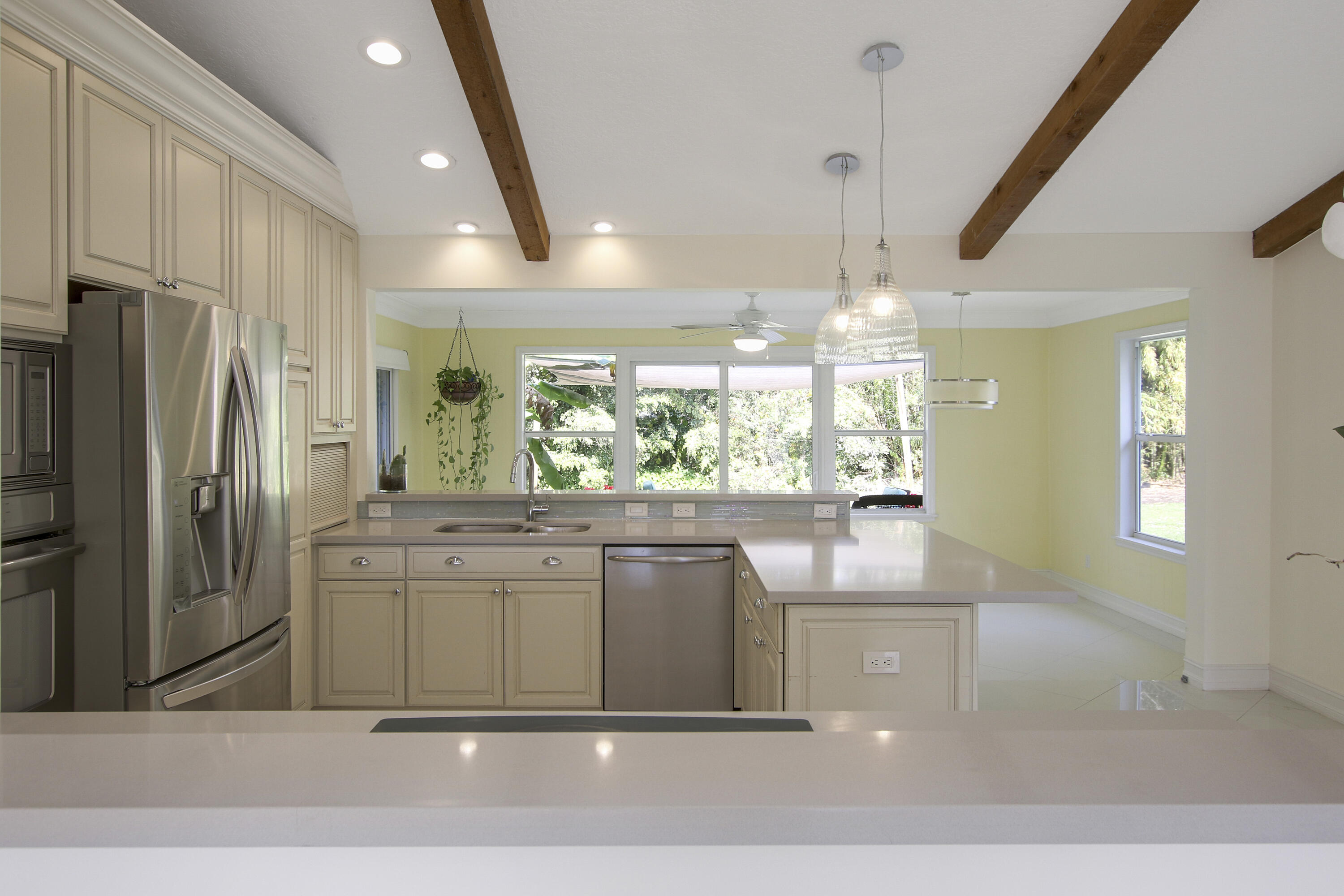 13431 153rd Road North Jupiter, FL 33478 - Photo 8 of 44 a kitchen with stainless steel appliances granite countertop a refrigerator a sink a stove and a refrigerator