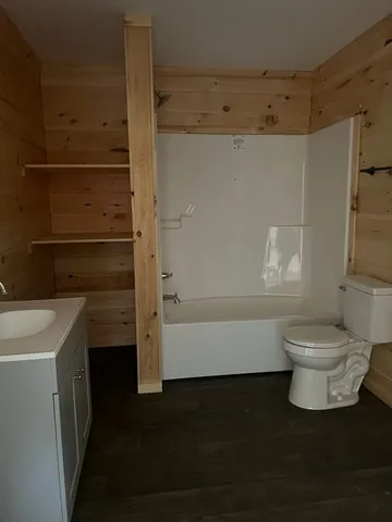 a bathroom with a toilet and a shower