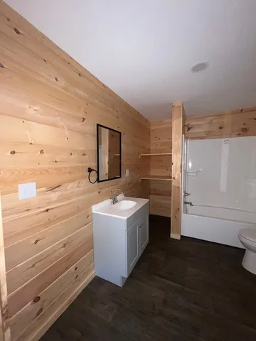a bathroom with a sink a mirror and bathtub