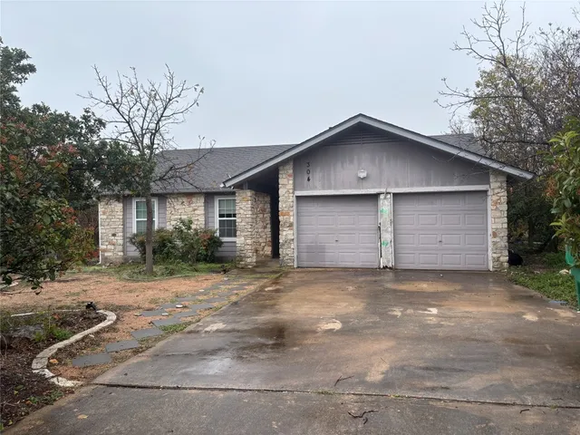 a view of a house with a yard and garage