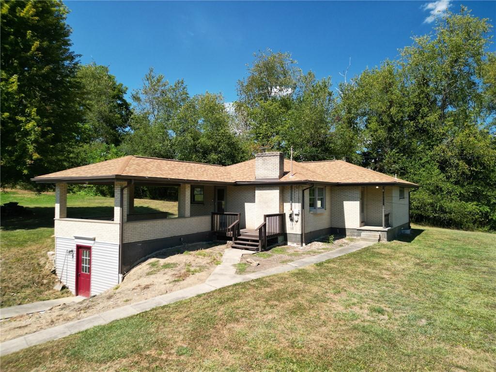 204 Marburger Road Evans City, PA 16033 - Photo 2 of 34 a table and chairs under an umbrella