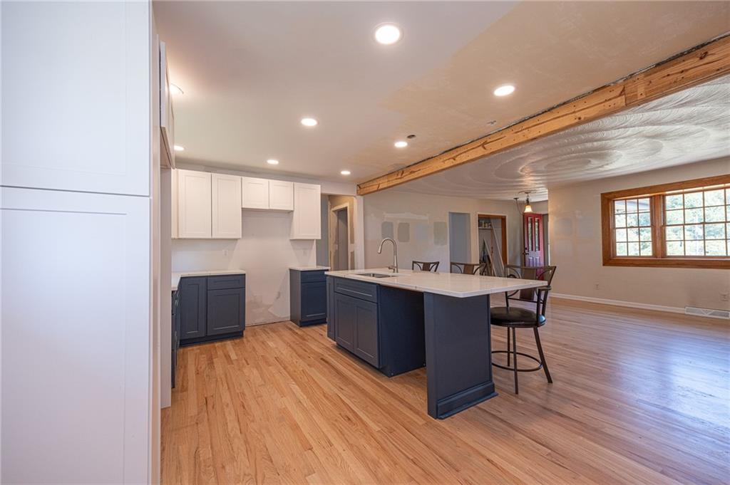 204 Marburger Road Evans City, PA 16033 - Photo 6 of 34 a kitchen with a sink cabinets and wooden floor