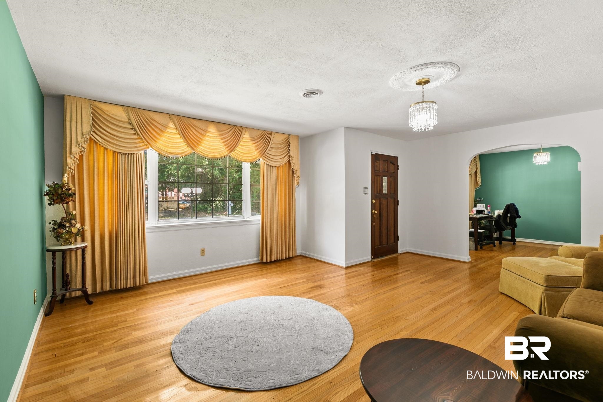 927 Cleveland Road Saraland, AL 36571 - Photo 4 of 80 Hardwood flooring throughout a spacious room with a large window