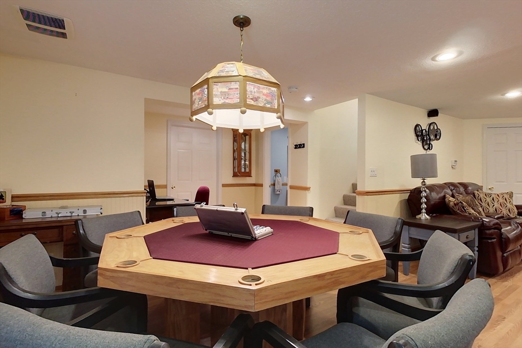 120 1/2 Lowell Road, Unit B Pepperell, MA 01463 - Photo 16 of 34 a room with a table chairs and a dining table