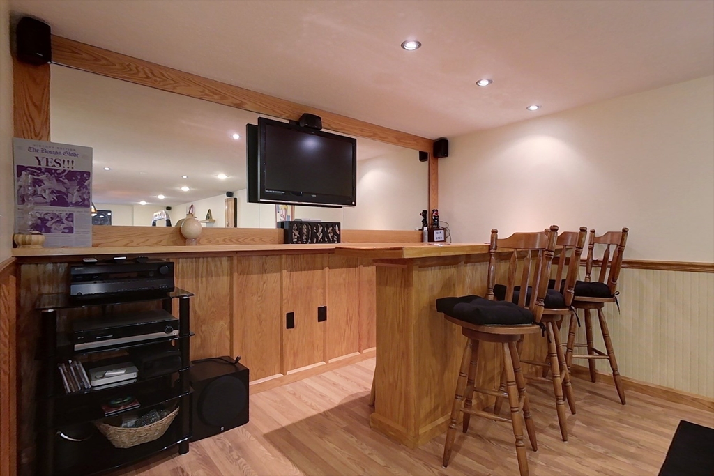 120 1/2 Lowell Road, Unit B Pepperell, MA 01463 - Photo 19 of 34 a kitchen with stainless steel appliances kitchen island granite countertop a sink and cabinets