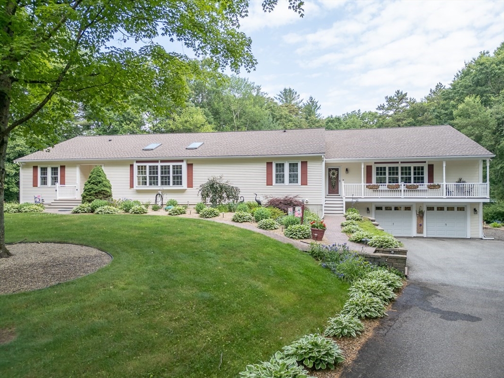 120 1/2 Lowell Road, Unit B Pepperell, MA 01463 - Photo 22 of 34 a view of a house with a yard and potted plants