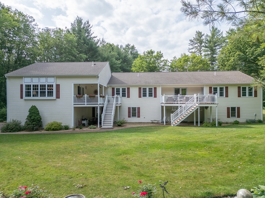 120 1/2 Lowell Road, Unit B Pepperell, MA 01463 - Photo 25 of 34 a view of a house with a yard