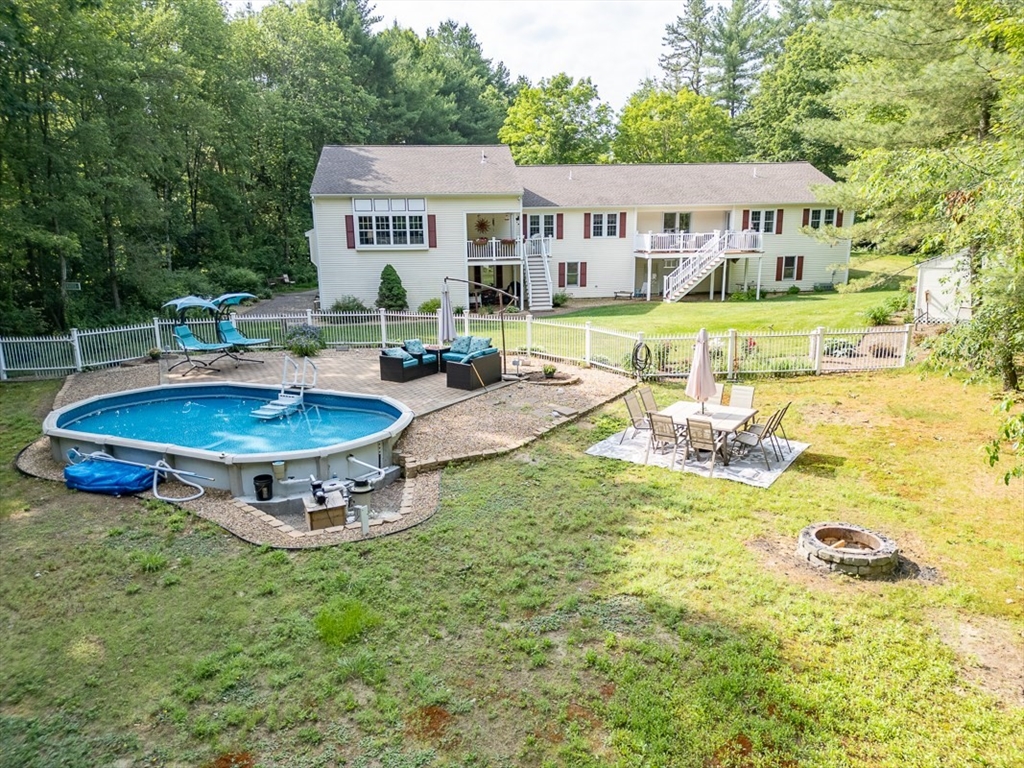 120 1/2 Lowell Road, Unit B Pepperell, MA 01463 - Photo 27 of 34 a view of a house with swimming pool and sitting area