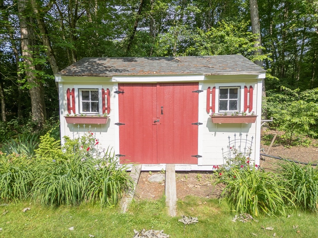 120 1/2 Lowell Road, Unit B Pepperell, MA 01463 - Photo 28 of 34 a front view of a house with garden