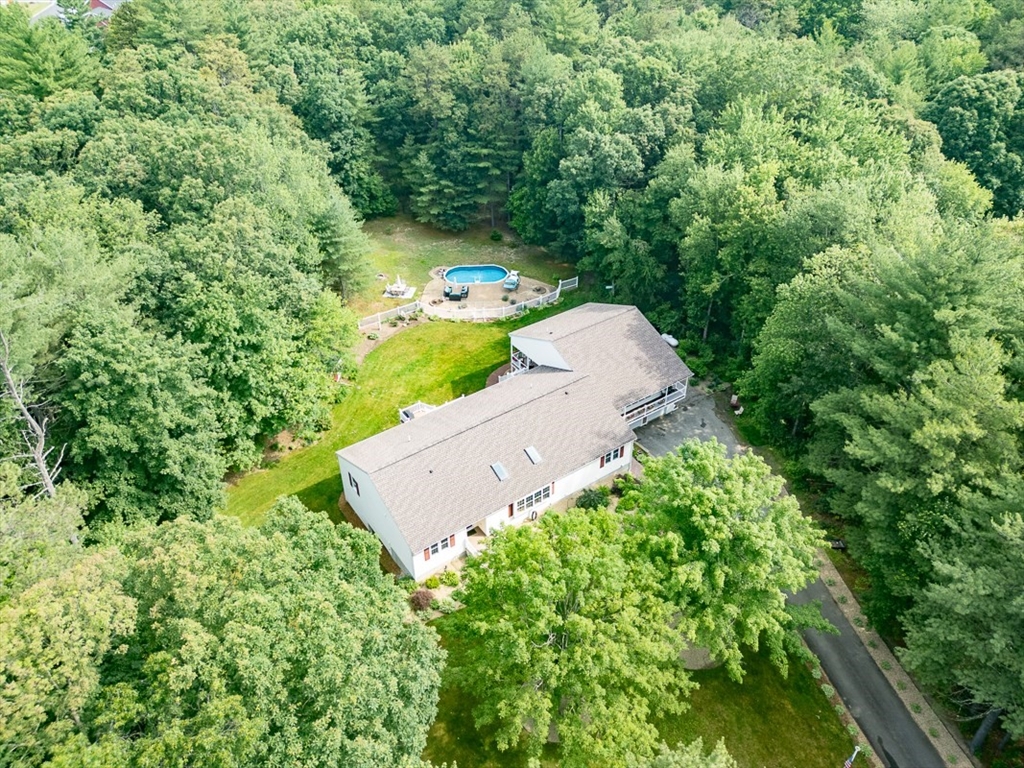 120 1/2 Lowell Road, Unit B Pepperell, MA 01463 - Photo 29 of 34 an aerial view of a house with a yard and lake view
