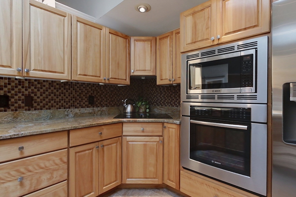 120 1/2 Lowell Road, Unit B Pepperell, MA 01463 - Photo 4 of 34 a kitchen with granite countertop white cabinets and stainless steel appliances