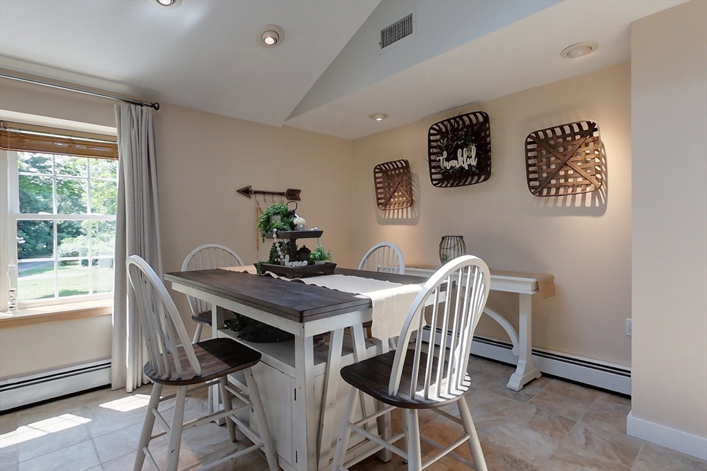 120 1/2 Lowell Road, Unit B Pepperell, MA 01463 - Photo 7 of 34 a view of a dining room with furniture and a window