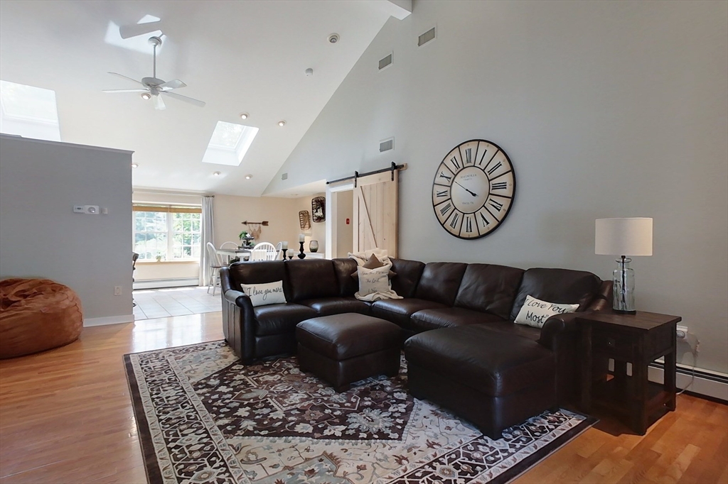 120 1/2 Lowell Road, Unit B Pepperell, MA 01463 - Photo 8 of 34 a living room with furniture and a rug