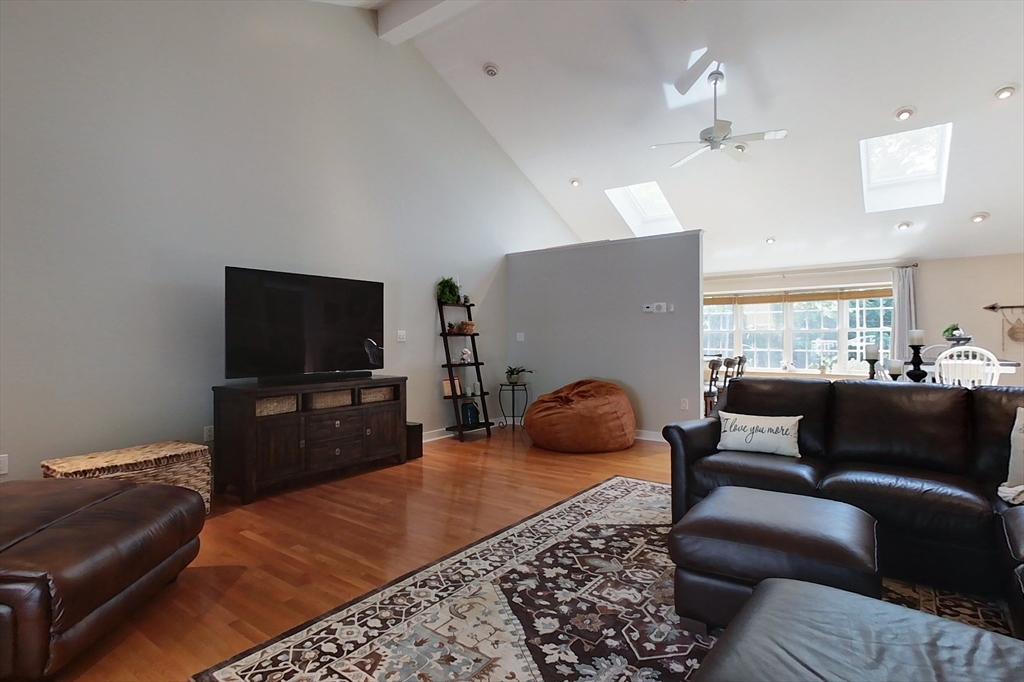 120 1/2 Lowell Road, Unit B Pepperell, MA 01463 - Photo 9 of 34 a living room with furniture and a flat screen tv