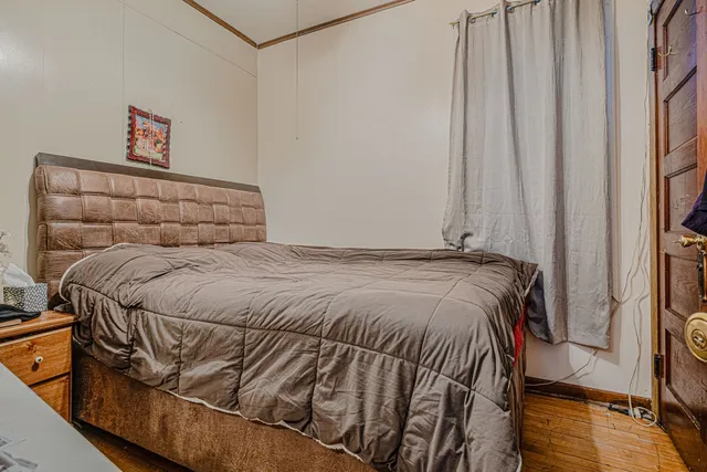 a bed sitting in a bedroom next to a window