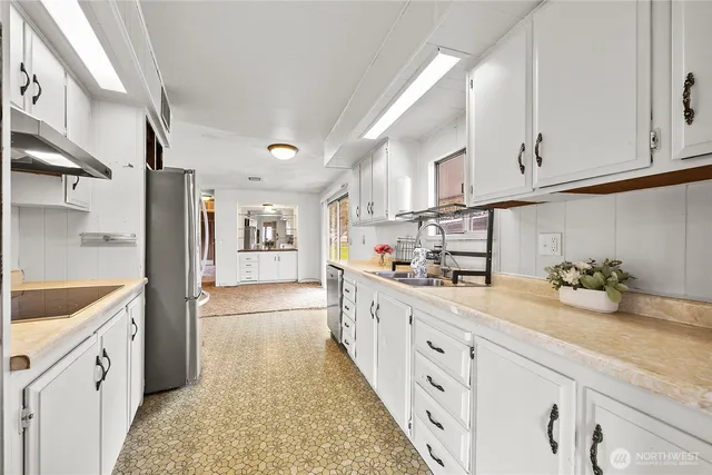 a kitchen with cabinets and window