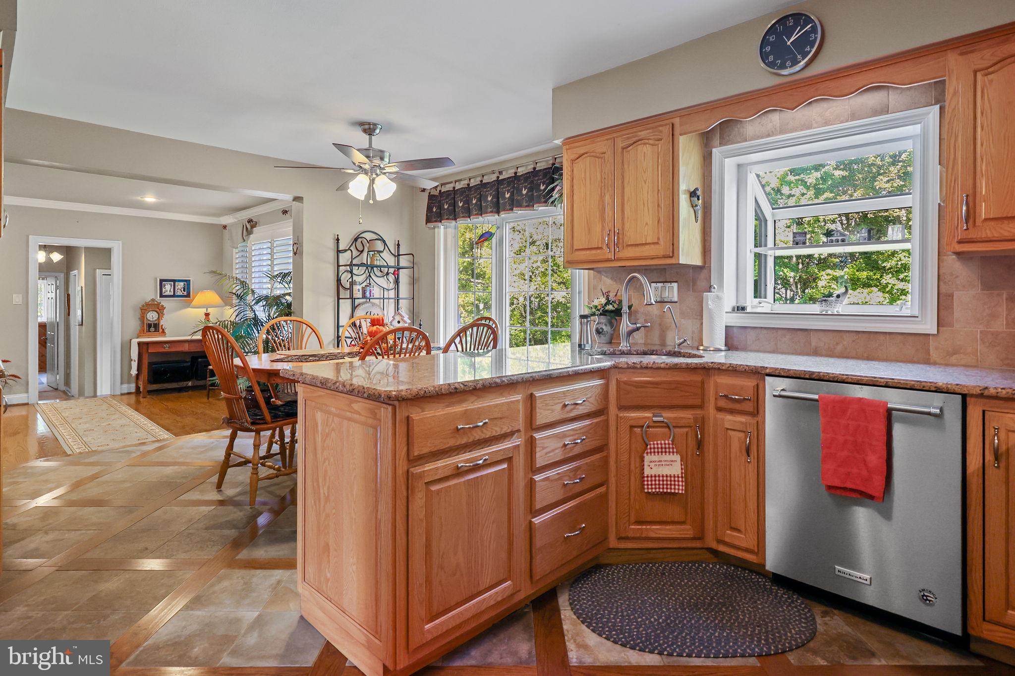 978 Weber Drive Yardley, PA 19067 - Photo 12 of 63 a kitchen with stainless steel appliances granite countertop a stove a sink dishwasher and a dining table with cabinets
