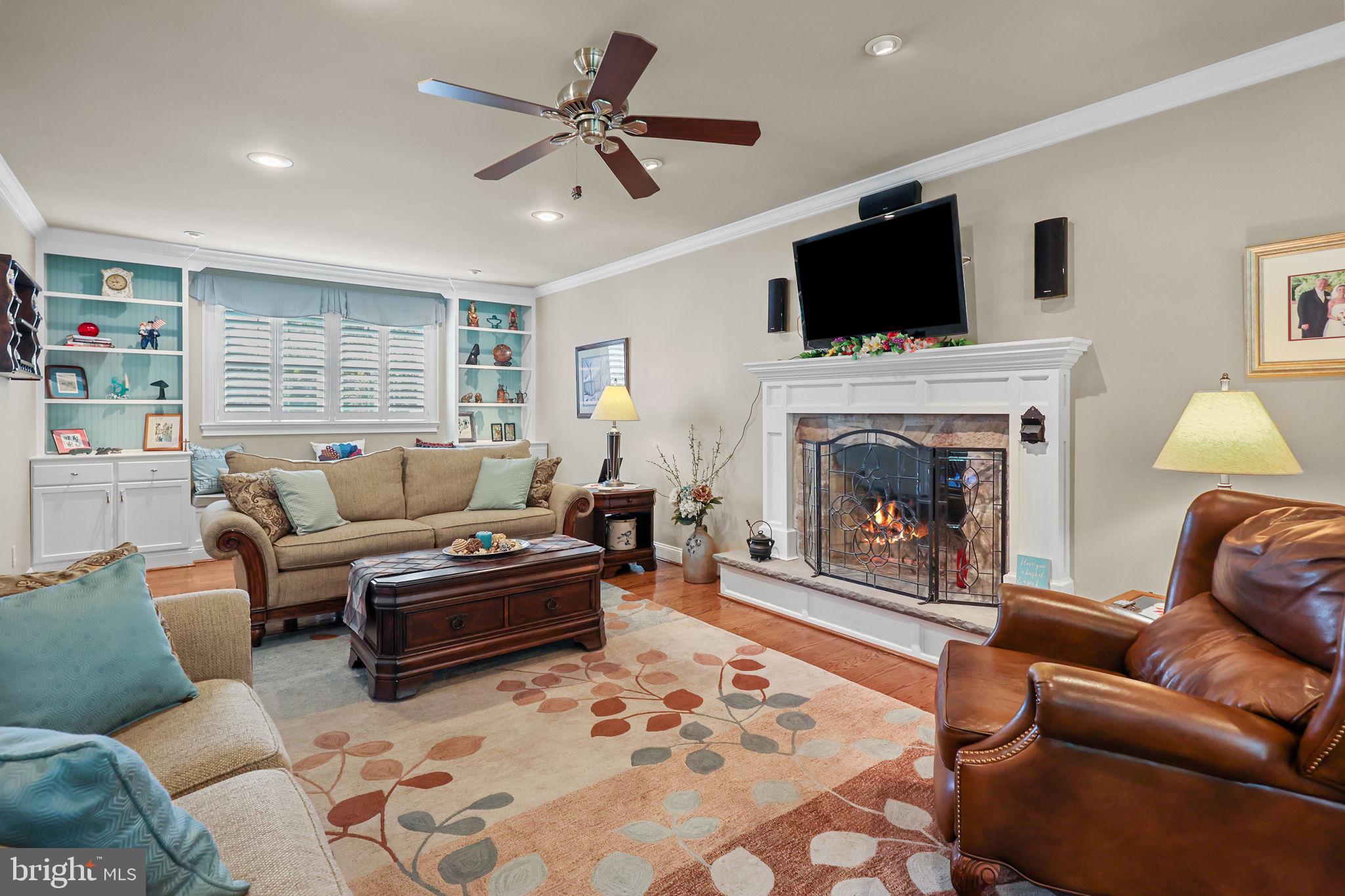 978 Weber Drive Yardley, PA 19067 - Photo 17 of 63 a living room with furniture a flat screen tv and a fireplace