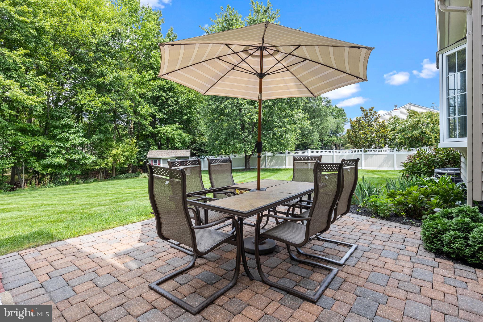 978 Weber Drive Yardley, PA 19067 - Photo 52 of 63 a view of a patio with table and chairs under an umbrella