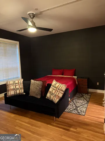 a bed sitting in a bedroom and wooden floor