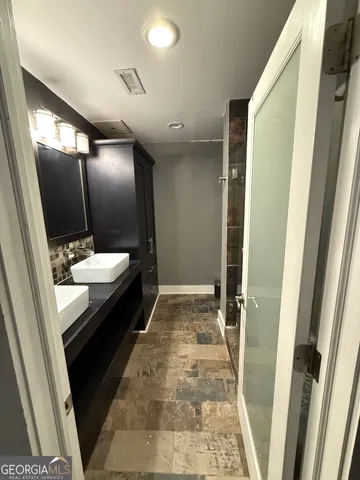 a bathroom with a sink and a mirror