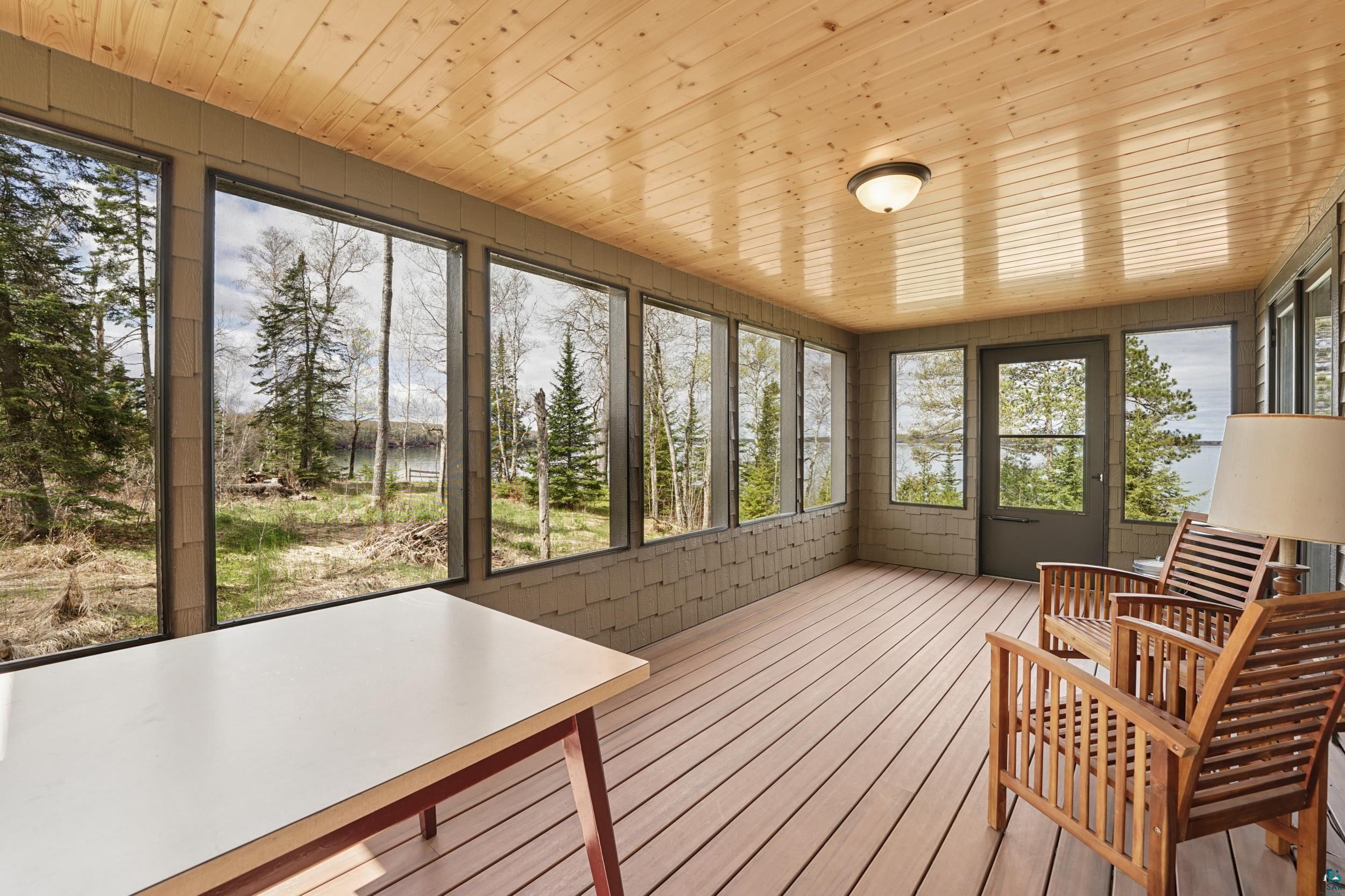 89095 West Romans Point Road Herbster, WI 54844 - Photo 11 of 30 Wood-paneled ceiling sunroom featuring multiple large windows, wood-finish flooring, and a screened door