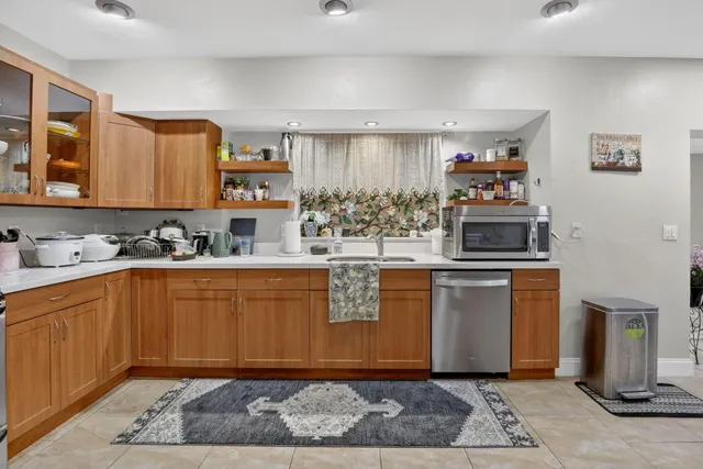 a kitchen with stainless steel appliances granite countertop a stove sink and cabinets